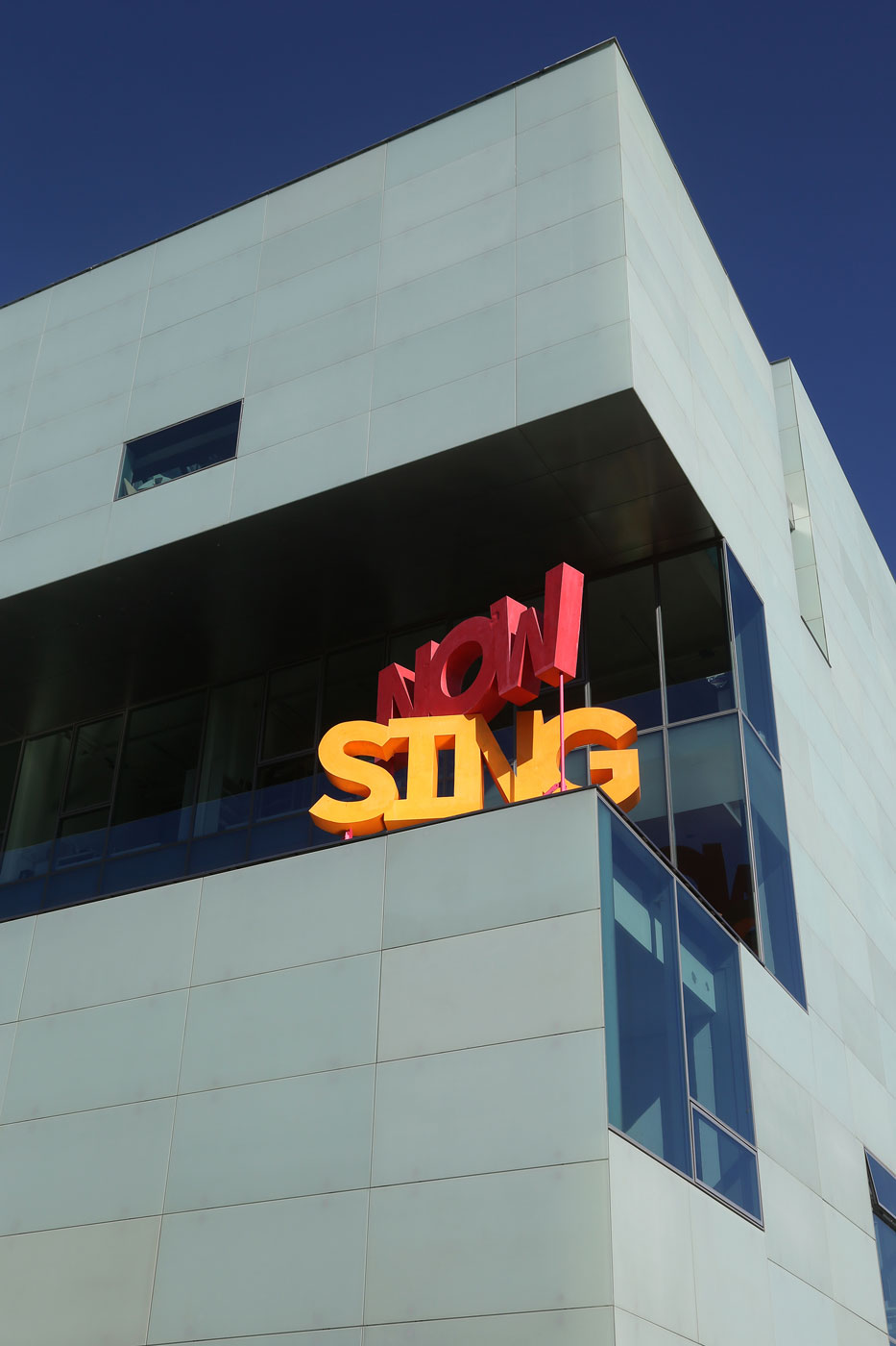 Now Sing, (2014), Michael Stumpf. Cast acrylic resin, painted steel, wooden base. Reid building balcony, The Glasgow School of Art.  From his exhibition, This Song Belongs to Those who Sing It, Mackintosh Museum, The Glasgow School of Art, Glasgow International Festival of Visual Art 2014. Photo: Janet Wilson.